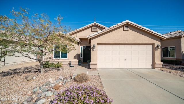 ranch-style house with a garage, concrete driveway, a tiled roof, and stucco siding