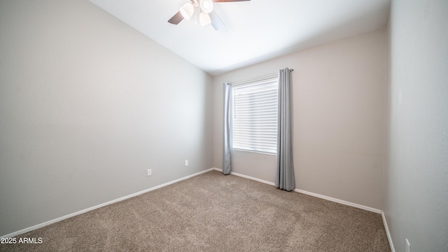 spare room with lofted ceiling, carpet flooring, ceiling fan, and baseboards