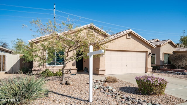 single story home with a garage, concrete driveway, a tiled roof, and stucco siding