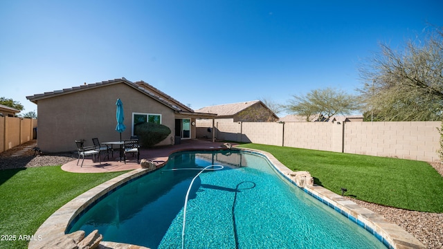 view of pool with a patio, a yard, a fenced backyard, and a fenced in pool