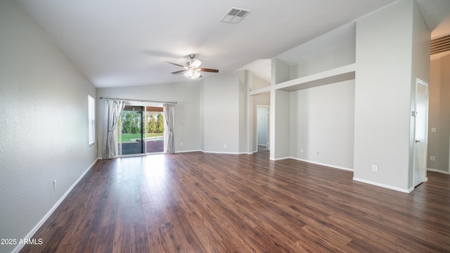 empty room featuring dark wood-type flooring, lofted ceiling, visible vents, and baseboards