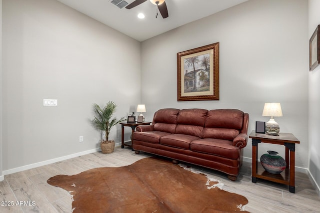 living room with light hardwood / wood-style floors and ceiling fan