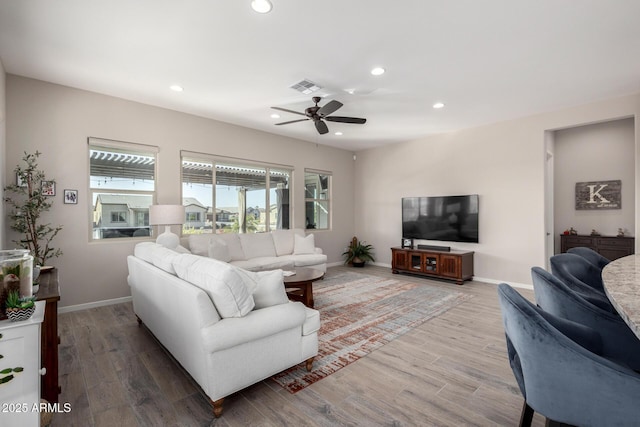 living room featuring hardwood / wood-style floors and ceiling fan