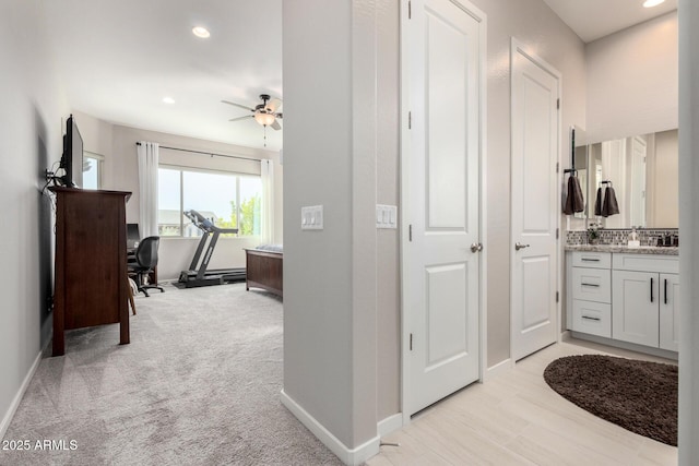 bathroom with vanity, ceiling fan, decorative backsplash, and a bath