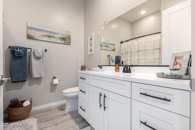 bathroom featuring hardwood / wood-style floors, vanity, and toilet