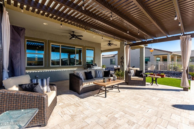 view of patio / terrace with an outdoor living space, ceiling fan, and a pergola