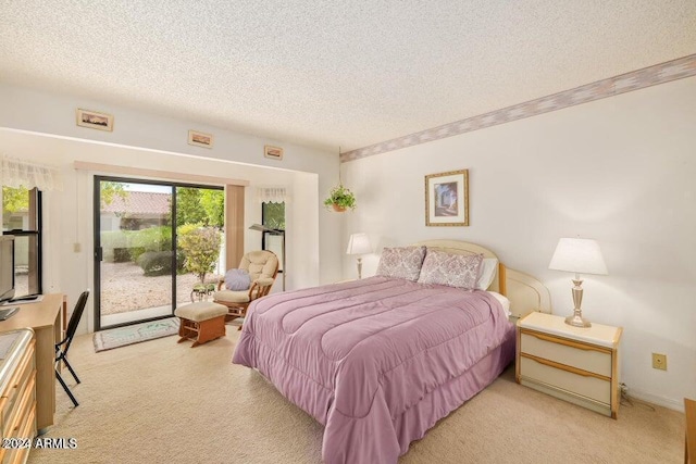 bedroom with access to exterior, light carpet, and a textured ceiling