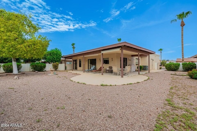 rear view of property featuring a patio