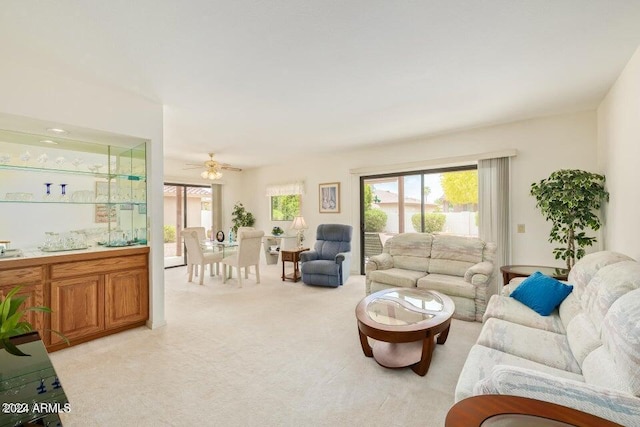 carpeted living room featuring ceiling fan