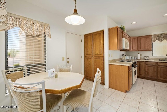 kitchen featuring pendant lighting, light tile patterned flooring, and white appliances