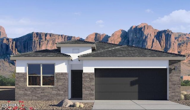 view of front of property featuring a mountain view and a garage