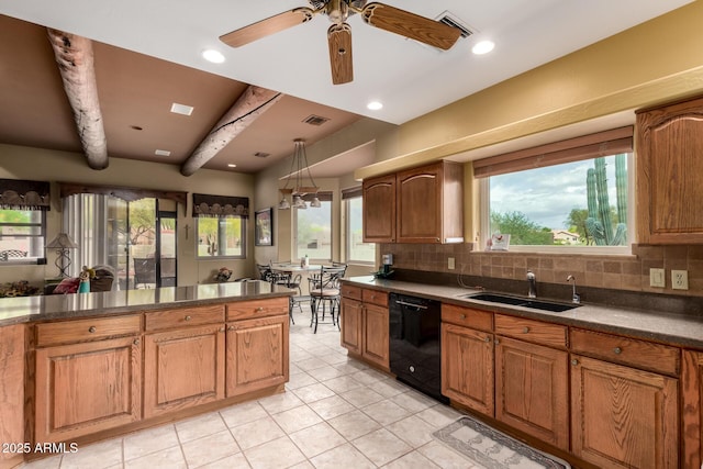 kitchen with dark countertops, a sink, and dishwasher