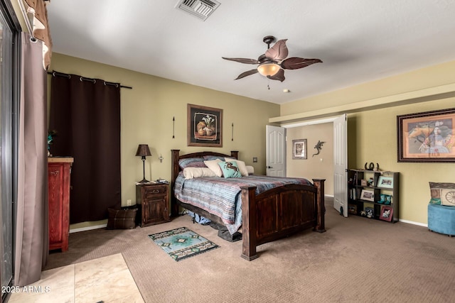 carpeted bedroom with visible vents, baseboards, and ceiling fan