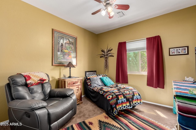 carpeted bedroom with visible vents, baseboards, and a ceiling fan
