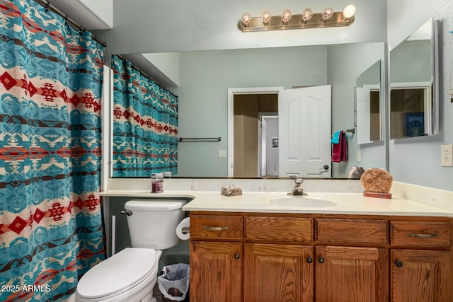 bathroom with toilet, curtained shower, and vanity