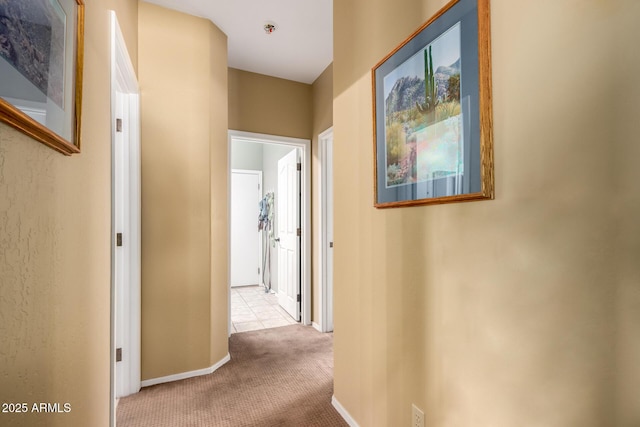 hall with carpet floors and baseboards