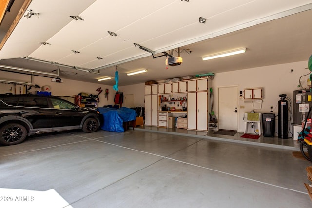 garage featuring electric water heater and a garage door opener
