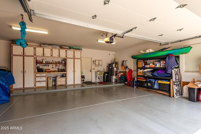garage with a sink, water heater, and a garage door opener