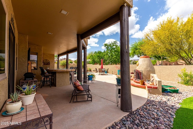 view of patio / terrace with a fenced backyard and outdoor dry bar