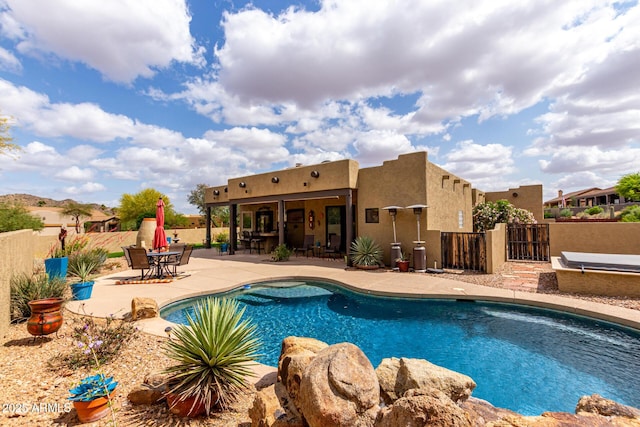 view of pool with outdoor dining area, a patio, fence private yard, and a fenced in pool
