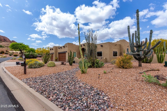 view of front of property with stucco siding and a garage