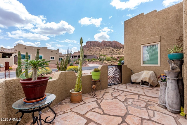 view of patio with a mountain view and a grill