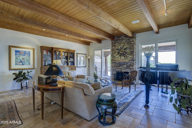 1401 E Boulder Pass, Carefree, AZ 85377 - living area with wooden ceiling, beamed ceiling, a stone fireplace, and stone tile floors