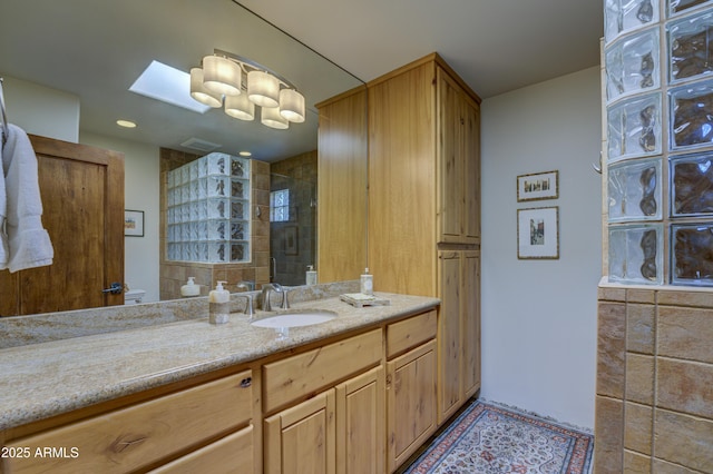 1401 E Boulder Pass, Carefree, AZ 85377 - bathroom featuring a tile shower, vanity, recessed lighting, a skylight, and visible vents