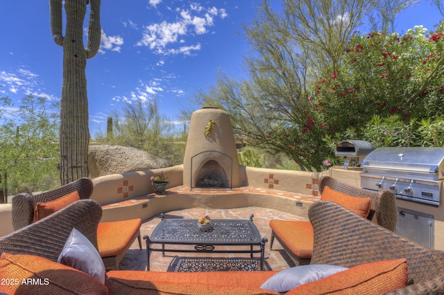 1401 E Boulder Pass, Carefree, AZ 85377 - view of patio / terrace featuring exterior kitchen, an outdoor living space with a fireplace, and area for grilling