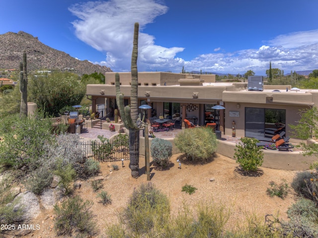 1401 E Boulder Pass, Carefree, AZ 85377 - back of house featuring a patio, fence, a mountain view, and stucco siding