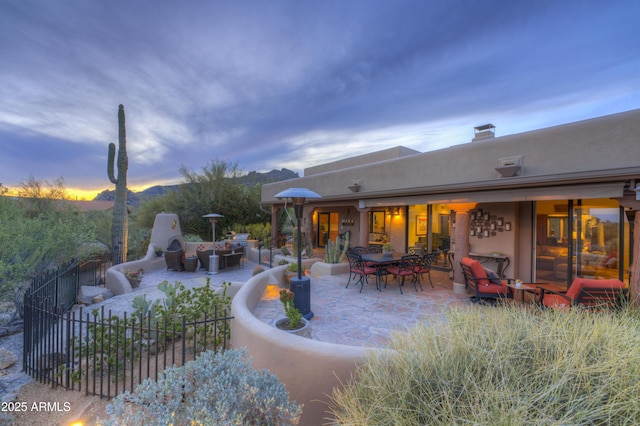 1401 E Boulder Pass, Carefree, AZ 85377 - patio terrace at dusk with fence and outdoor dining area