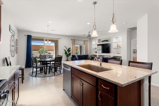 26947 W Adam Ave, Buckeye, AZ 85396 - kitchen featuring a sink, open floor plan, appliances with stainless steel finishes, a center island with sink, and pendant lighting