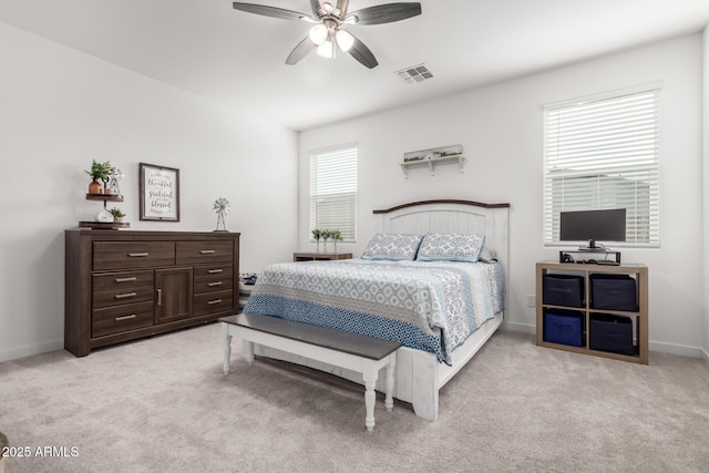 bedroom with ceiling fan and light carpet