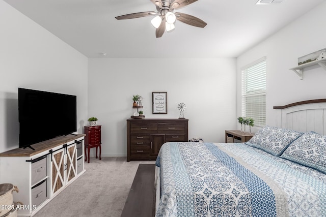 bedroom featuring light colored carpet and ceiling fan