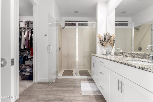 bathroom featuring vanity and an enclosed shower