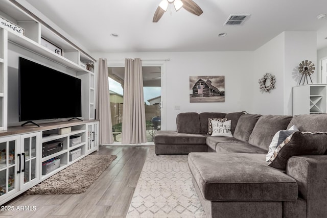 living room with hardwood / wood-style flooring and ceiling fan