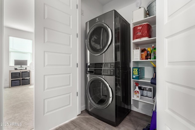 laundry room with light carpet and stacked washer and clothes dryer