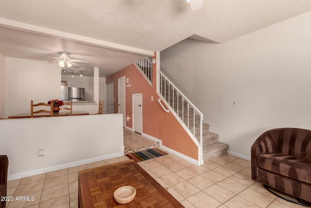 5808 E Brown Rd Unit 119, Mesa, AZ 85205 - entrance foyer featuring light tile patterned floors, baseboards, a textured ceiling, stairs, and ceiling fan