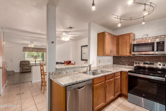 5808 E Brown Rd Unit 119, Mesa, AZ 85205 - kitchen with ceiling fan, light tile patterned floors, stainless steel appliances, and a sink