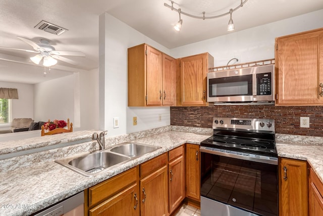 5808 E Brown Rd Unit 119, Mesa, AZ 85205 - kitchen featuring stainless steel appliances, a sink, visible vents, backsplash, and a ceiling fan