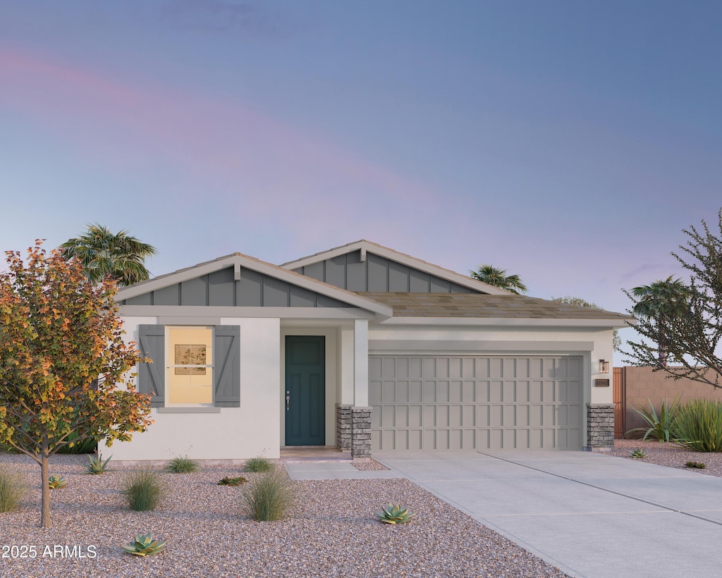 single story home featuring concrete driveway and an attached garage