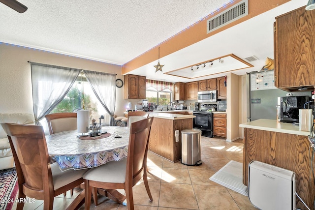 18903 N 97th Ln, Peoria, AZ 85382 - dining room with light tile patterned floors and a textured ceiling