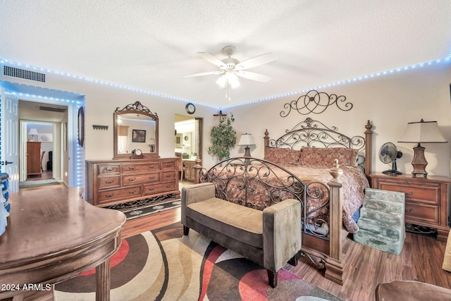 bedroom featuring ceiling fan, a textured ceiling, and hardwood / wood-style flooring