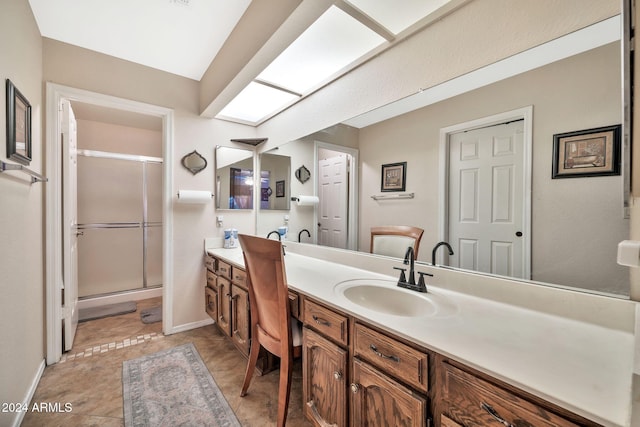 bathroom with tile patterned flooring, vanity, and an enclosed shower