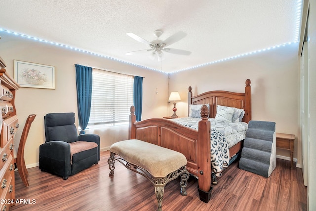 bedroom with hardwood / wood-style floors, ceiling fan, and a textured ceiling