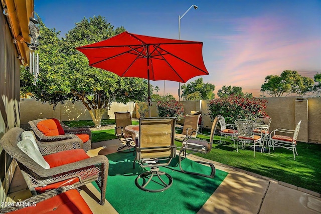 18903 N 97th Ln, Peoria, AZ 85382 - patio terrace at dusk with outdoor dining area and a patio area