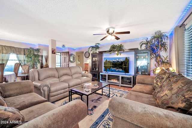 living room featuring hardwood / wood-style floors, a textured ceiling, and ceiling fan