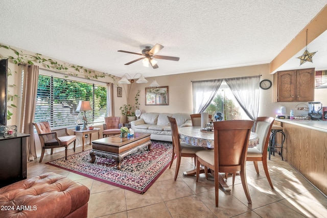 tiled living room featuring a textured ceiling, ceiling fan, and sink