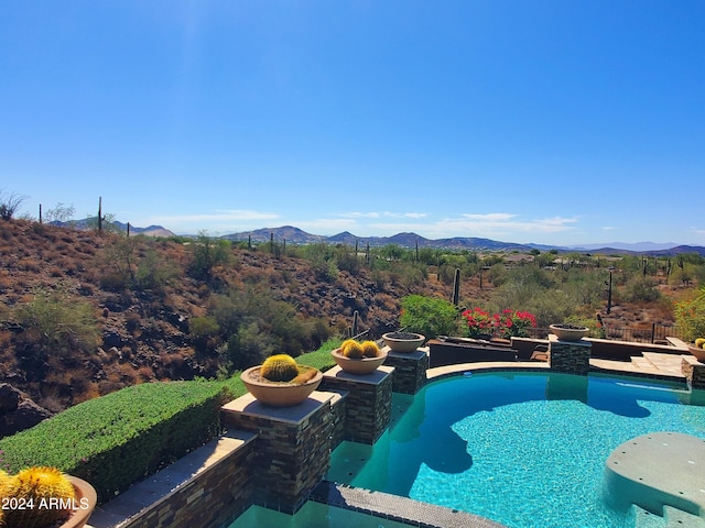 view of pool with a mountain view