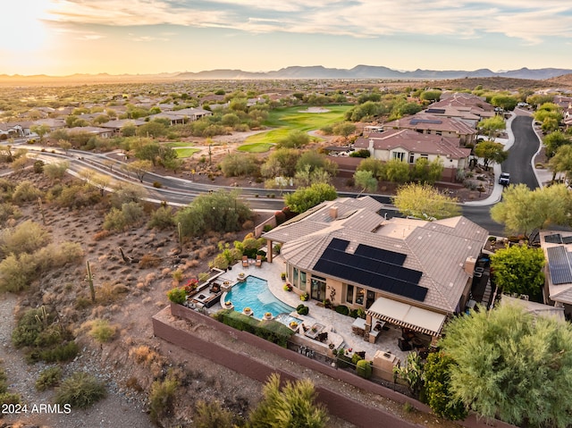 aerial view at dusk featuring a mountain view